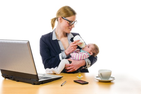 Adult business woman wearing a costume and supplied her newborn daughter in the office workplace, isolated against a white background の写真素材