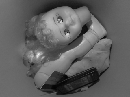 PARTS OF A DOLL AS FOUND IN DUSTBIN.の写真素材