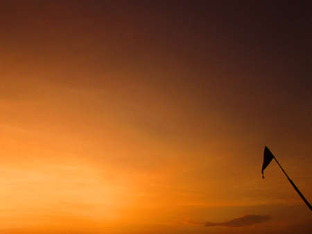 Flag flying at sunsetの写真素材
