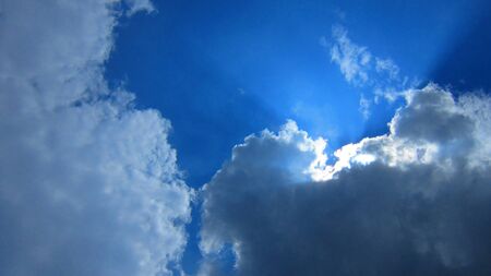  AFTERNOON SUN BEHIND CLOUDY SKY 