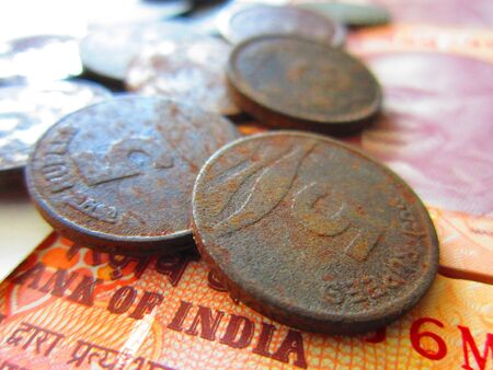 OLD INDIAN COIN ON NEW INDIAN MONEYの写真素材