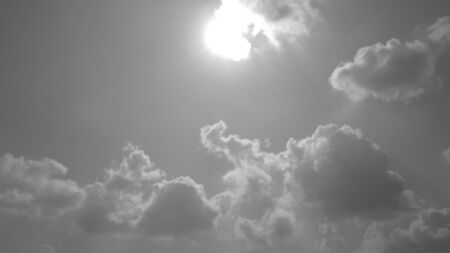 bright sun in cloudy skyの写真素材
