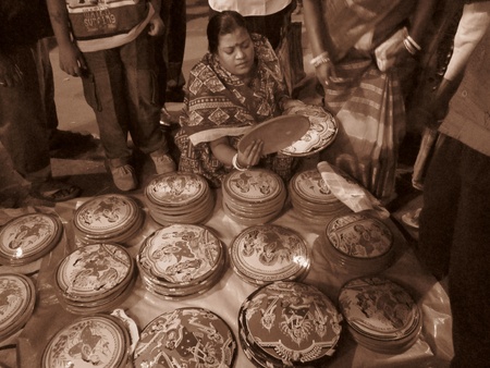 A WOMAN PURCHASING OBJECTS AT A FAIR. SHOT IN SEPIA MODE AT EVENING HOURS ON 24.10.12 AT AGARPARA, KOLKATA, WESTBENGAL, INDIA.のeditorial素材