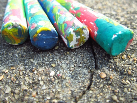 COLORFUL CHALKS LINED UP ON ROUGH GROUND-EDUCATIONAL CONCEPTの写真素材