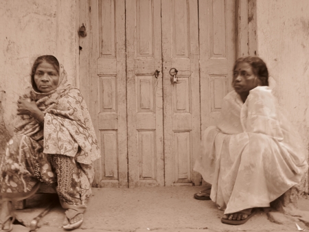 TWO WOMAN SITTING IN FRONT OF A SHOP. SHOT AT MORNING HOURS ON 03 NOVEMBER 2012 AT  PATNA, BIHAR, INDIAのeditorial素材