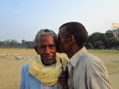 A MAN IS WHISPERING AT THE EAR OF ANOTHER OLD MAN. SHOT AT AFTERNOON HOURS ON 05 NOVEMBER 2012 AT  GANDHI MAIDAN, PATNA, BIHAR, INDIA, ASIA.のeditorial素材