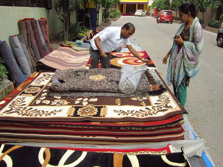 SELLER SELLING CARPET.SHOT AT CALCUTTA, INDIA: AFTERNOON HOURS ON NOVEMBER 17,2012のeditorial素材