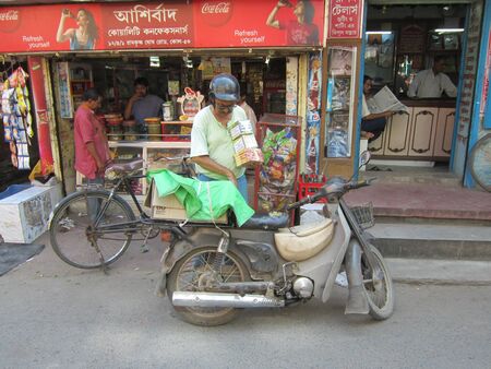 SALESMAN SELLING GOODS ION CYCLE.SHOT AT CALCUTTA, INDIA: AFTERNOON HOURS ON NOVEMBER 18,2012.のeditorial素材