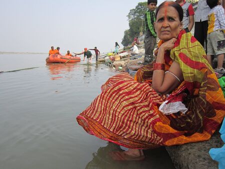 WOMAN PERFORMING  CHATTH PUJA .SHOT AT PATNA, BIHAR, INDIA: MORNING HOURS ON NOVEMBER 19,2012.