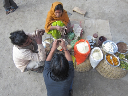woman making litti at fair. SHOT DURING MORNING HOURS ON 02.12.12 AT SONEPUR FAIR, SONEPUR, BIHAR, INDIA.のeditorial素材