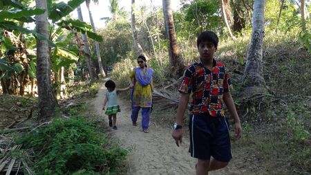 UNIDENTIFIED TRAVELERS WALK IN RURAL ISLAND SET UP. SHOT AT AFTERNOON HOURS ON MARCH 17, 2013 IN NEIL ISLAND, ANDAMAN, INDIA.のeditorial素材