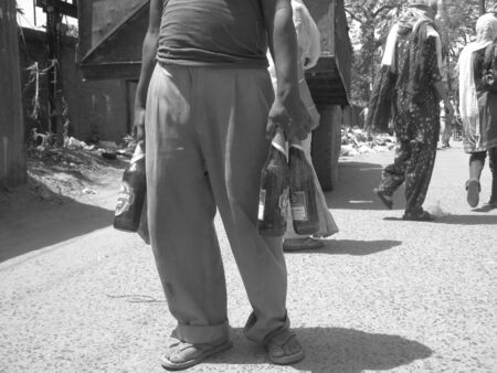 UNIDENITIED MAN CARRIES CARRY USED BEER BOTTLE TO BE USED AS JUNK. SHOT AT MORNING HOURS ON APRIL...