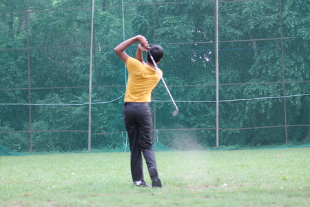 Playing golf at Patna Golf Academy. Shot at evening hours on 02.08.14 at Patna, Bihar, India.のeditorial素材
