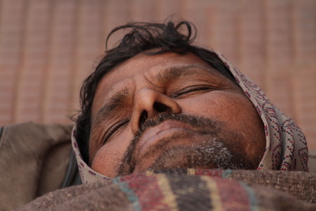 Poor Indian street dweller. Shot at morning hours at Gandhi Maidan, Patna, Bihar, India on 12.02.15.のeditorial素材