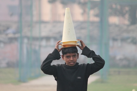 Grounds boy as Reserve Bank of India Officers play friendly cricket. Shot at morning hours on 21.02.2015 at Patna, Bihar, India.のeditorial素材
