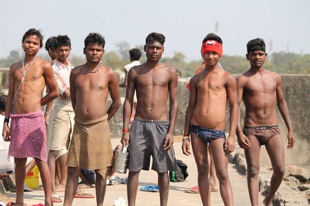 Indian laborers at cooling pond take break. Shot at afternoon hours at Bokaro, Jharkhand, India on...
