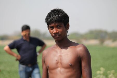 Indian laborers at cooling pond take break. Shot at afternoon hours at Bokaro, Jharkhand, India on 26.02,2015.のeditorial素材