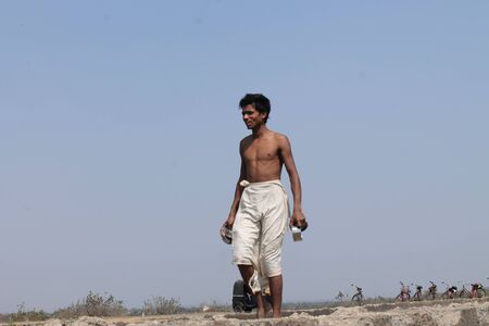 Indian laborers at cooling pond take break. Shot at afternoon hours at Bokaro, Jharkhand, India on 26.02,2015.のeditorial素材