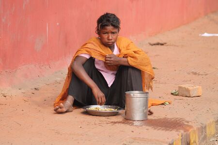 Indian poor having lunch. Street photo, Shot at Gandhi Maidan, Patna, Bihar, India on 20.02.15 at afternoon hours.のeditorial素材