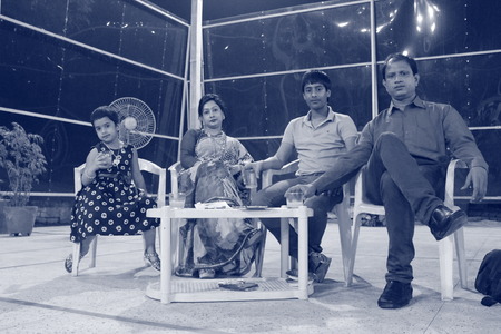 An Indian family enjoys party. Shot on 01.03.15,evening hours at Patna, India.のeditorial素材