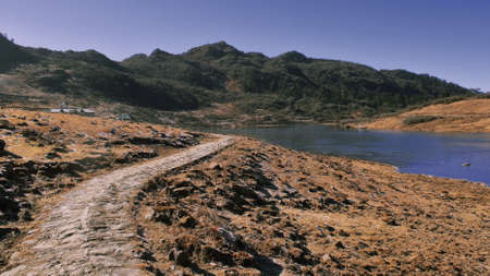 dusty zigzag countryroad is going through the alpine valley in tawang district of arunachal pradesh,...