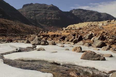 frozen mountain steam (nuranang chu) near sela pass, arunachal pradesh in north east indiaの写真素材