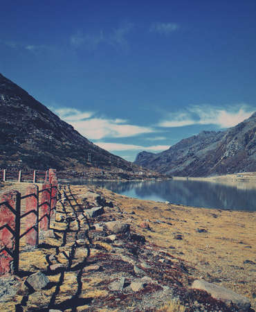 scenic alpine meadows and beautiful sela lake surrounded by himalaya mountains in tawang district of arunachal pradesh, north east indiaの写真素材