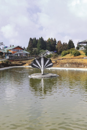 mythological snake statue and scenic jore pokhari lake with rural landscape, located on himalayan foothills near darjeeling in west bengal, indiaの写真素材