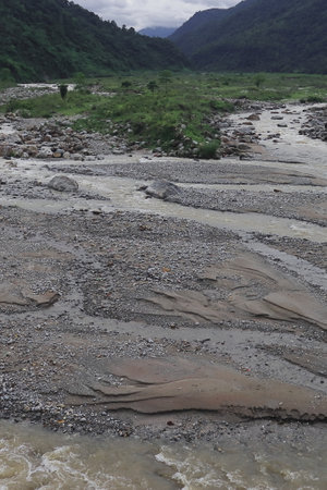 beautiful river valley, flowing stream, forest and himalaya foothills of terai - dooars region. birds eye view of flowing balason river in monsoon season at dudhiaの写真素材