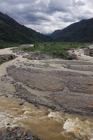 beautiful river valley, flowing stream, forest and himalaya foothills of terai - dooars region. birds eye view of flowing balason river in monsoon season at dudhiaの写真素材