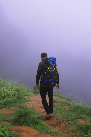 Darjeeling, West Bengal, India - 26th June 2023: Backpacking and hiking misty forest and mountains,...