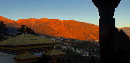 beautiful heritage and old townscape of tawang in the darkness, from tawang monastery. the morning sun rays illuminated the himalaya mountainsの写真素材