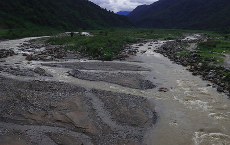 mountain river balason, flowing through the lush green valley of terai region on himalayan foothills...