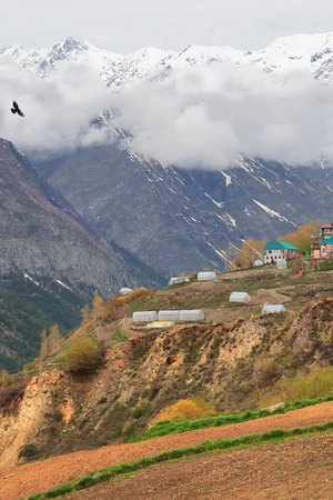 scenic mountain landscape, remote mountain village in autumn season, snowcapped himalayan range in lahaul valley near kyelang, himachal pradesh, indiaの写真素材