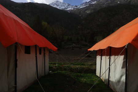 beautiful campsite area at jispa, surrounded by snowcapped himalaya mountains in lahaul valley, adventure traveling in himachal pradesh, indiaの写真素材