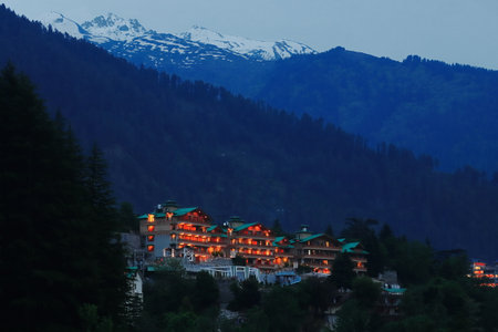 panoramic view of manali hill station with illuminated light during dusk, snowcapped himalaya mountains in the background, himachal pradesh, indiaの写真素材