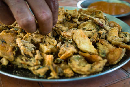 A tabletop shot of tea and pakodas on a road side stall in India. Most famous go to food in India.の写真素材