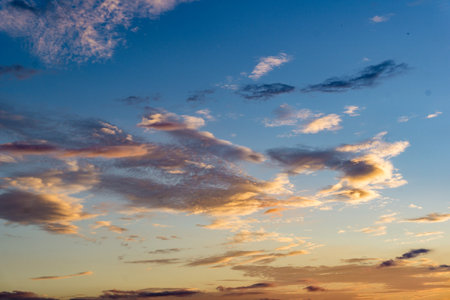 Different shapes of clouds forming at the evening golden hour on skies of Uttarakhand India.の写真素材