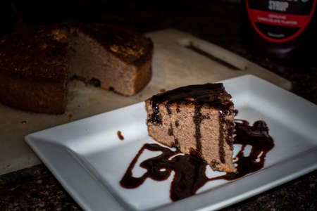 A slice of home made cinnamon cake with melted chocolate on top. Indiaの写真素材