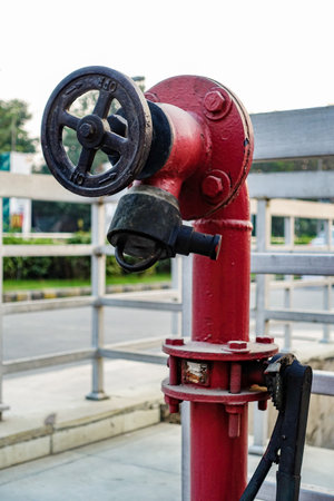 A black and red water hydrant outside a mall in Delhi capital city of India.