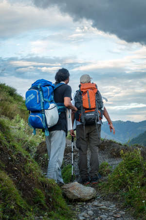 September 9th 2021 Uttarakhand INDIA. Hikers with backpacks and walking sticks on a Himalayan trek.