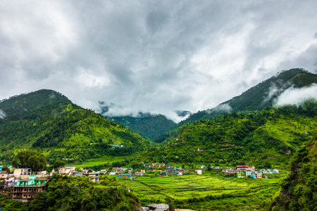 A wide angle shot of a village in the mountains of Lower Himalayan region of Uttarakhand State, India.の写真素材