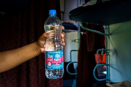 July 4th 2022 Haridwar India. A man holding Rail Neer packaged drinking water bottle offered by Indian Railways.の写真素材
