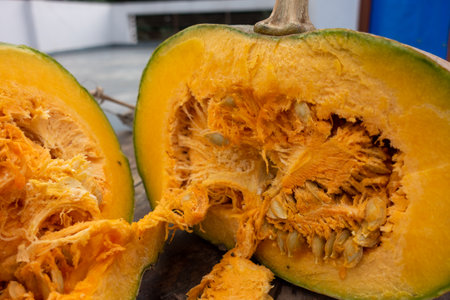 Close up shot of Pumpkin with vine stump in two halves with exposed internal pulp. Indiaの写真素材