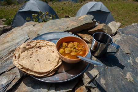 Indian Roti-Sabzi ( Indian bread and vegetable curry) food platter in the outdoor during camping in the Himalayas. Uttarakhand India.の写真素材