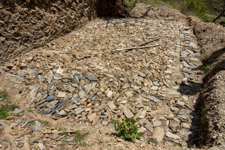 Building rock bed water harvesting tank amidst Uttarakhand hills, India. Innovative construction for...