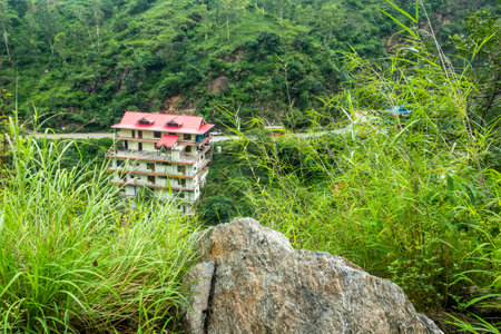 August 30th 2023, Himachal Pradesh, India. Mountain-side multistory building in Himachal Pradesh,...