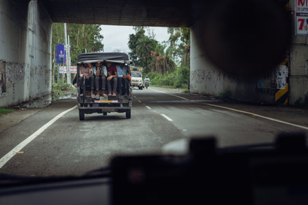 Aug2nd2024, Uttarakhand India. Artistic shot from inside a moving vehicle showing an overcrowded 3-wheeler (tuktuk) carrying people in Uttarakhand, India.の写真素材