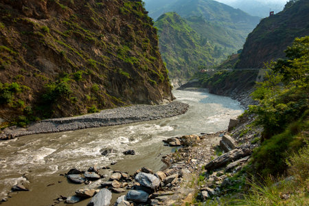 The Ravi River meandering through lush landscapes and valleys of Himachal Pradesh during the monsoon...
