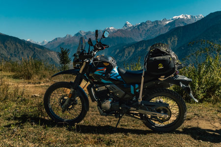 Nov.18th 2024 Uttarakhand India. An adventure motorcycle fully loaded with luggage, set against the stunning backdrop of the Gangotri Range glaciers in Uttarakhand, India.の写真素材
